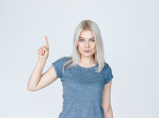 Woman pointing up at copy space over white background