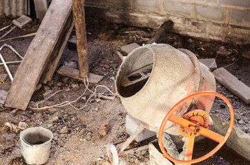 old dirty cement mixer at a construction site.