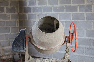old dirty cement mixer at a construction site.