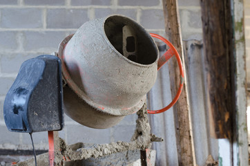 old dirty cement mixer at a construction site.