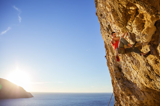 Rock climber on overhanging cliff. Kalymnos Island, Greece.