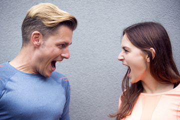 portrait of sporty couple screaming at each other