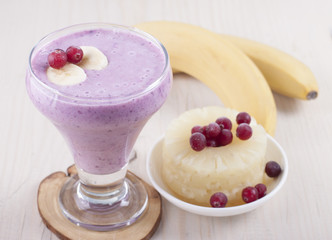   Smoothies of banana, canned pineapple and frozen cranberry  .