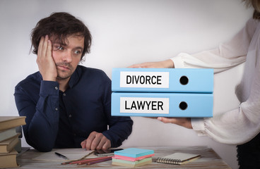 Divorce and Lawyer. Two binders in the hands of women