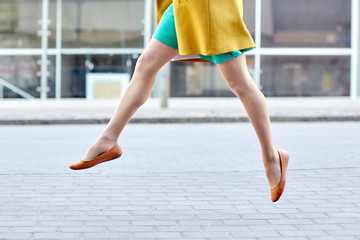 young woman or teenage girl legs on city street