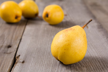 Fresh ripe organic yello pears on rustic wooden table, natural background, diet food.