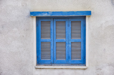Fototapeta na wymiar Old window with closed shutters