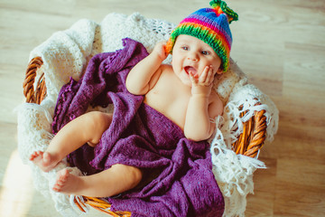great happy child lying in a large basket