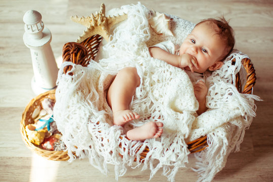 great happy baby lying on a white kerchief