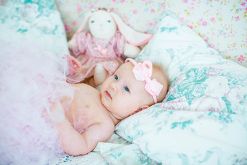 incredible little babygirl lying on light blanket