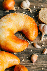 Tasty bun lays on a wooden table. Background.