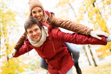 happy young couple having fun in autumn park