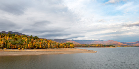 Ashokan Reservoir in the Catskills with Fall Colors and Dramatic Sky in the Mid-Hudson Valley. Reservoir is part of the NYC water supply, a destination for hikers and a home for Eagles.