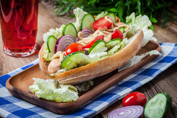 Homemade sandwich on a wooden table.