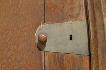 Part of an old door with the door handle.