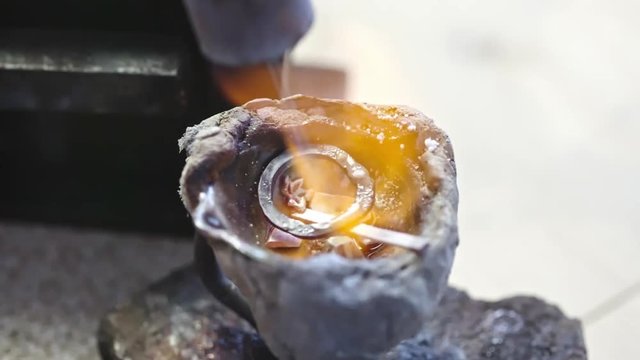 Time lapse of process of melting precious metal with torch for creating jewelry