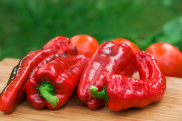 Red fresh pepper fruits on wooden Board
