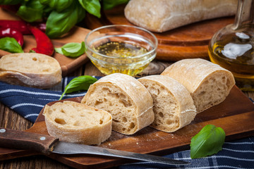 Sliced ciabatta bread on cutting board.