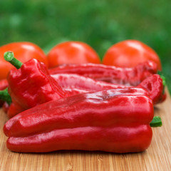 Red fresh pepper fruits on wooden Board
