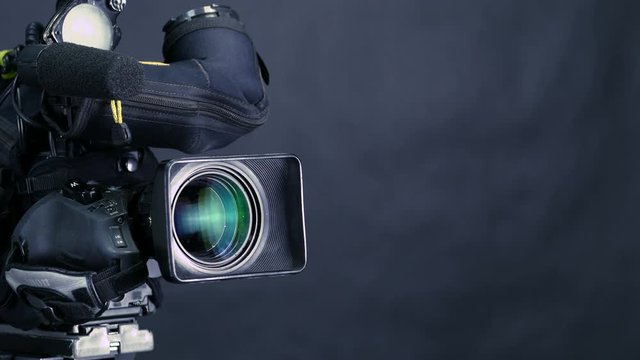 Studio broadcasting camera isolated on black background. 4K.