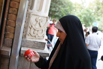 Beautiful Muslim woman spending time on traditional Iranian baza - obrazy, fototapety, plakaty