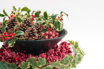 Festive Christmas decoration with holly and ivy on a white background