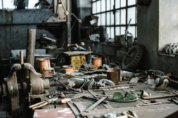Workbench facing natural light in an old industrial workshop 
