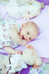 Happy little girl on a blanket