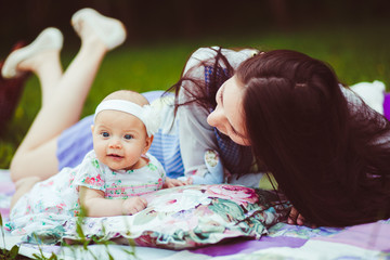 Mother and daughter lying in a meadow