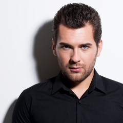 Fototapeta premium Portrait of young man in black shirt.