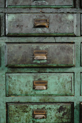Green drawers of a workshop with patina