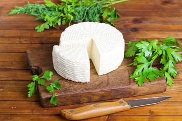 Soft salty cheese on a wooden table