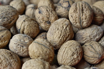 Macro detail of a heap of nuts (walnuts) as a symbol of healthy snack and organic food 