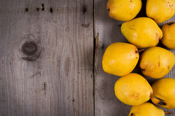 Fresh ripe organic yello pears on rustic wooden table, natural background, diet food.