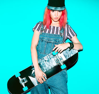 Pretty Teenager girl with red hair and skateboard Urban style