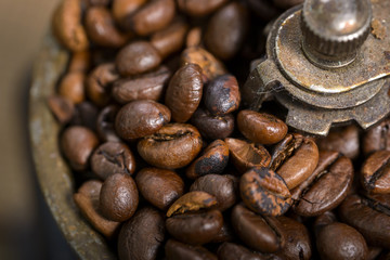 macro coffee beans in old coffee grinder