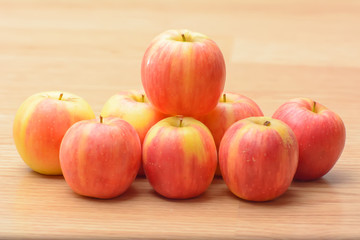 Naklejka na ściany i meble Many mini apples on the wood table.