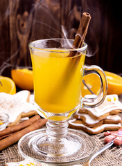 Hot orange tea in glass cup.Steam and cinnamon stick.