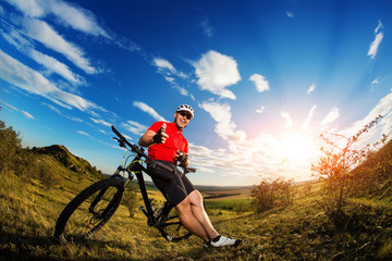 Fototapeta na wymiar Low angle view of man riding bicycle against sky