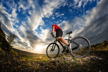Fototapeta na wymiar cyclist riding a bike on nature trail in the mountains.