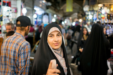 Beautiful Muslim woman spending time on traditional Iranian baza