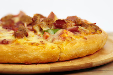 Pizza on a wooden tray.