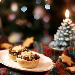 Christmas pastry filled with apples, almonds and chocolate with star shaped cookies. Selective focus and festive background.
