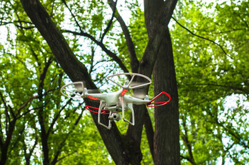 Fototapeta premium Drone flying between the trees in the park