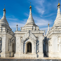Fototapeta na wymiar Sandamuni Pagoda with row of white pagodas. Amazing architecture of Buddhist Temples at Mandalay. Myanmar (Burma) travel landscapes and destinations
