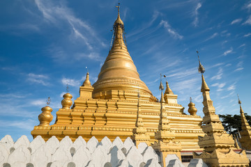 Fototapeta premium Golden Sandamuni Pagoda with row of white pagodas. Amazing architecture of Buddhist Temples at Mandalay. Myanmar (Burma) travel landscapes and destinations