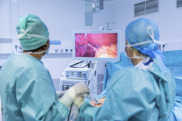 Surgeons performing surgery in operating Theater. - 124370033