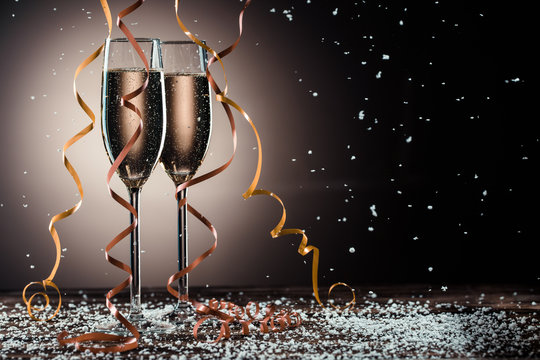 Romantic image of two glasses with sparkling champagne and ribbons
