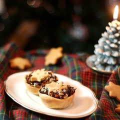 Christmas pastry filled with apples, almonds and chocolate with star shaped cookies. Selective focus and festive background.
