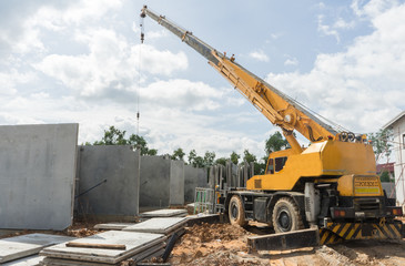 Construction site crane is used to placing precast concrete pane